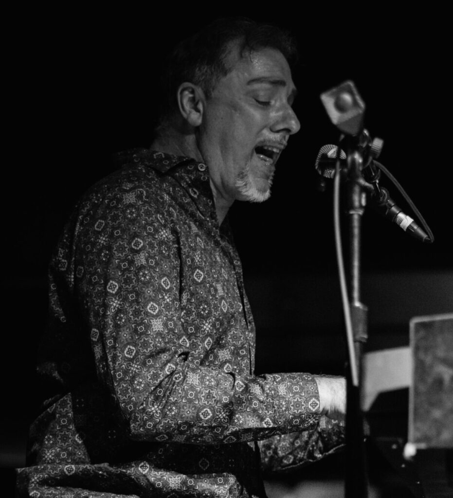 Man singing playing piano