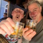 Two men holding drinks